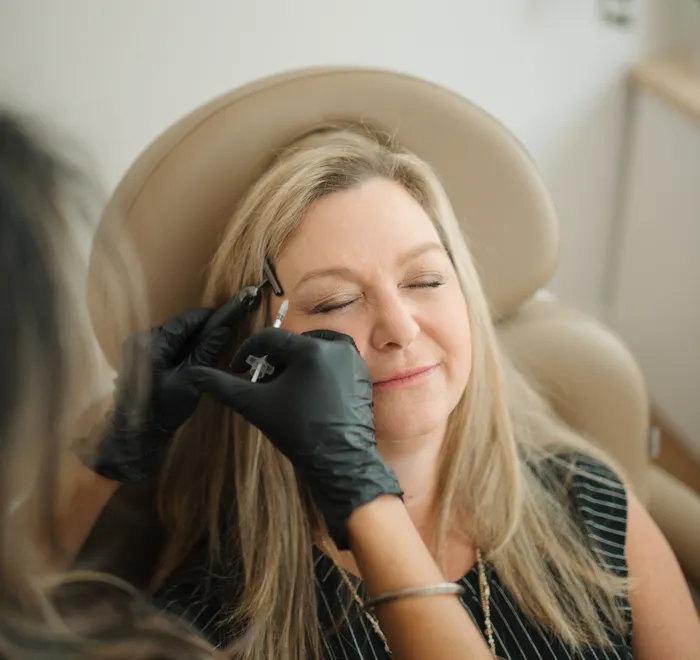 Botox injection to the brow, client relaxed at Oak Haus