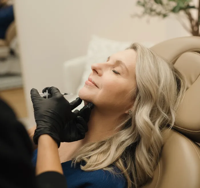 Provider administering Botox to a client at Oak Haus