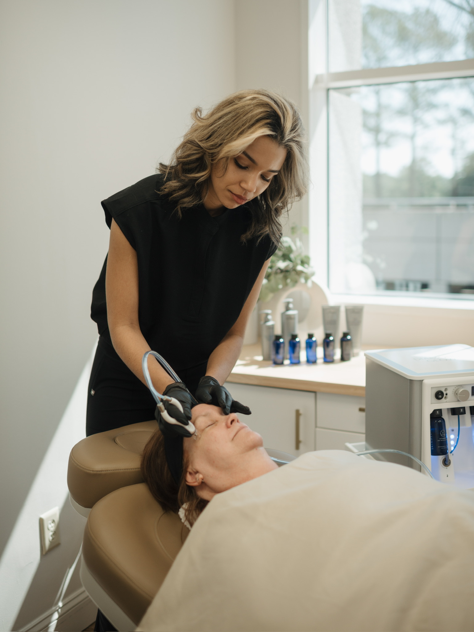 Bree performing a DiamondGlow facial treatment at Oak Haus